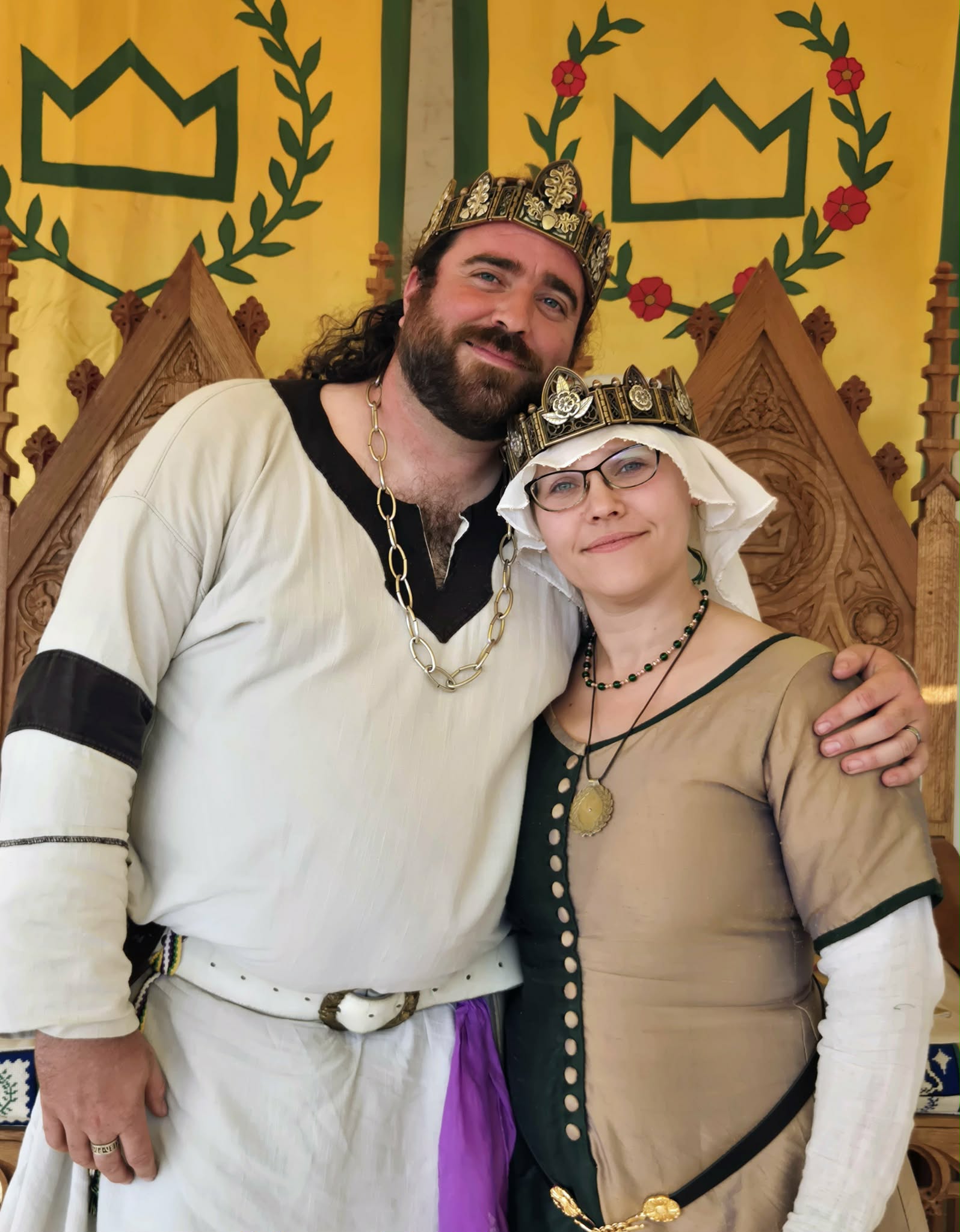 d1c73121-443b-4d8f-8e36-a6086907b892 Roric and Sibyl wearing the hinged Crowns made by Hugo in front of the thrones and banners of the King and Queen of the West